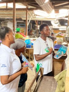 The President, Mr. Hamidu and his team explaining things to a trader.